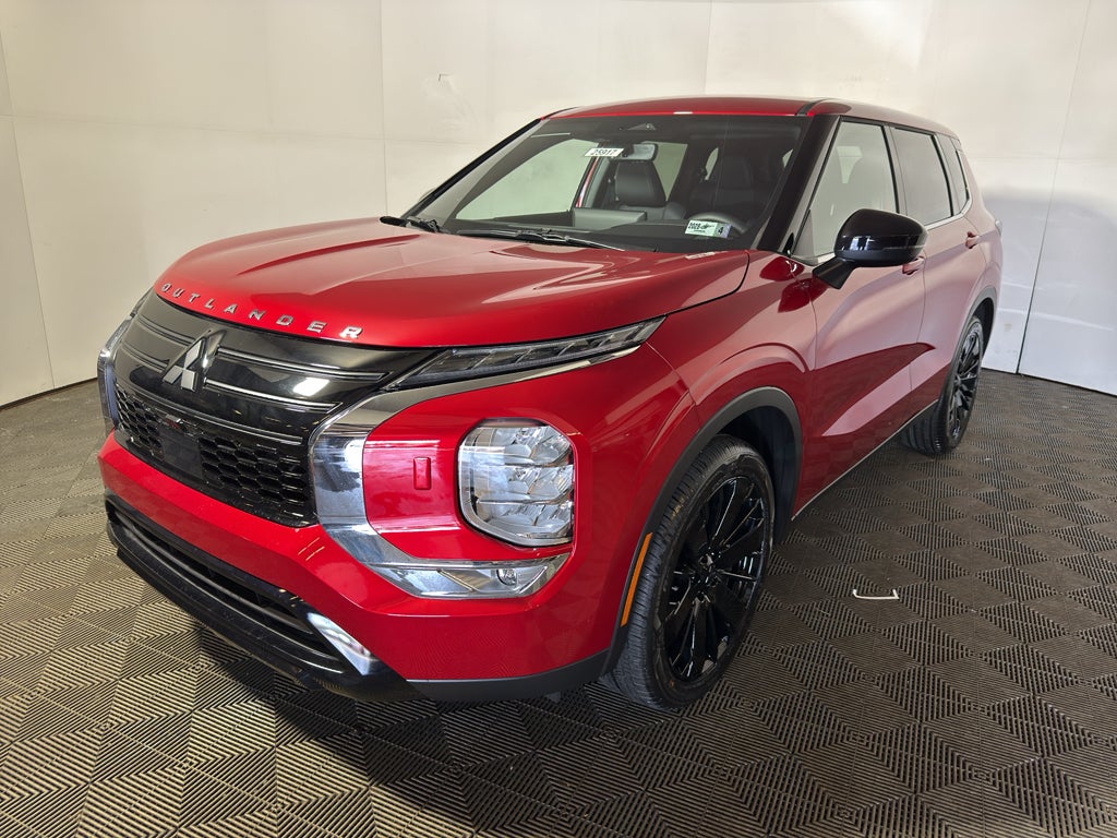 2026 Mitsubishi Outlander LE in Red Diamond — front three-quarter view